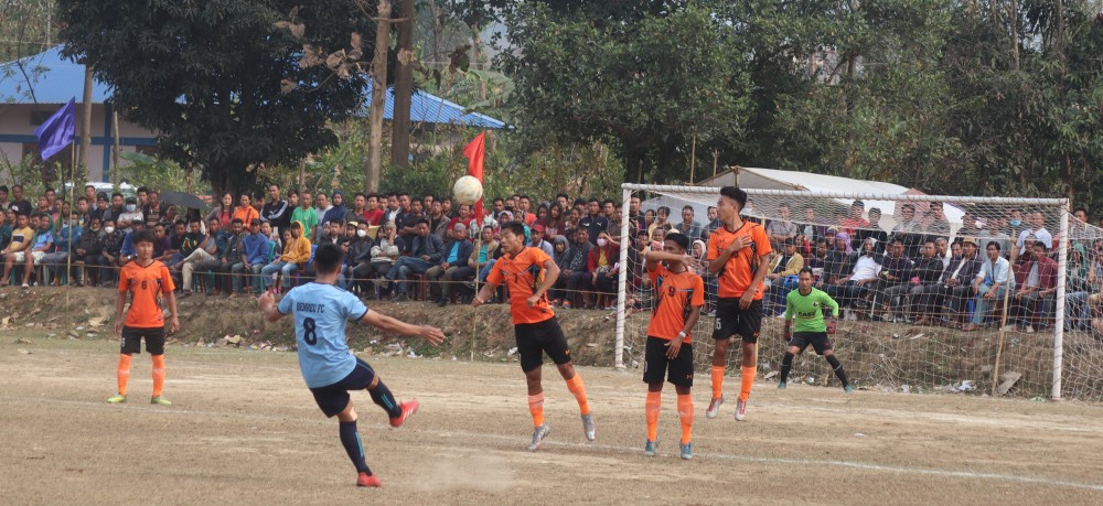 Players of Benreu FC (blue)  and Jalukie B Youth (A) in orange jersey seen in action during the second semifinal match of the tournament at Jalukie 'B' local ground.